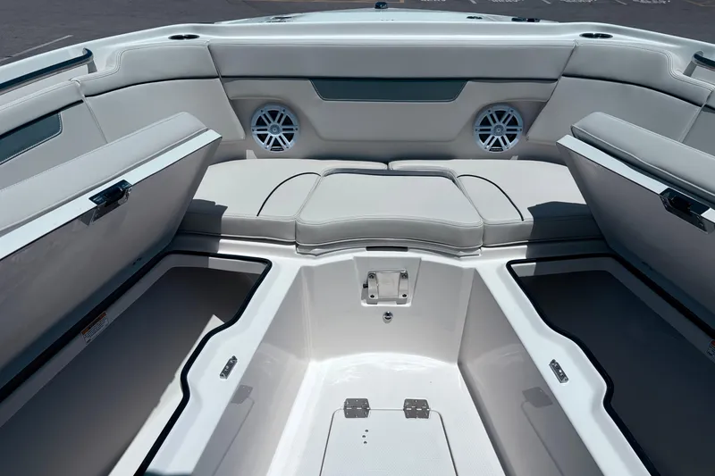 Slide: The Image of 2026 Sailfish 252 CC boat interior with open storage compartments and cushioned seating. - 28