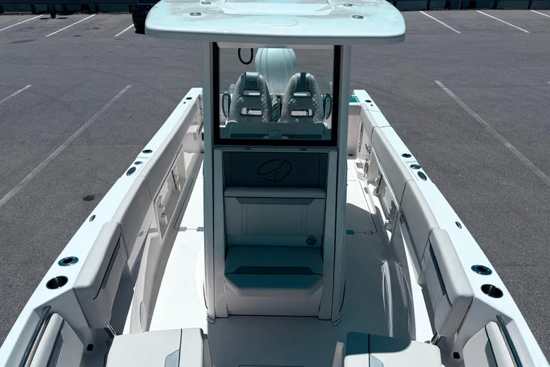 Slide: The Image of 2026 Sailfish 252 CC boat interior with seating and console, parked in a lot. - 29