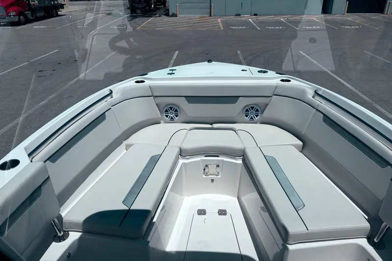 Slide: The Image of 2026 Sailfish 252 CC boat interior with cushioned seating and cup holders. - 31