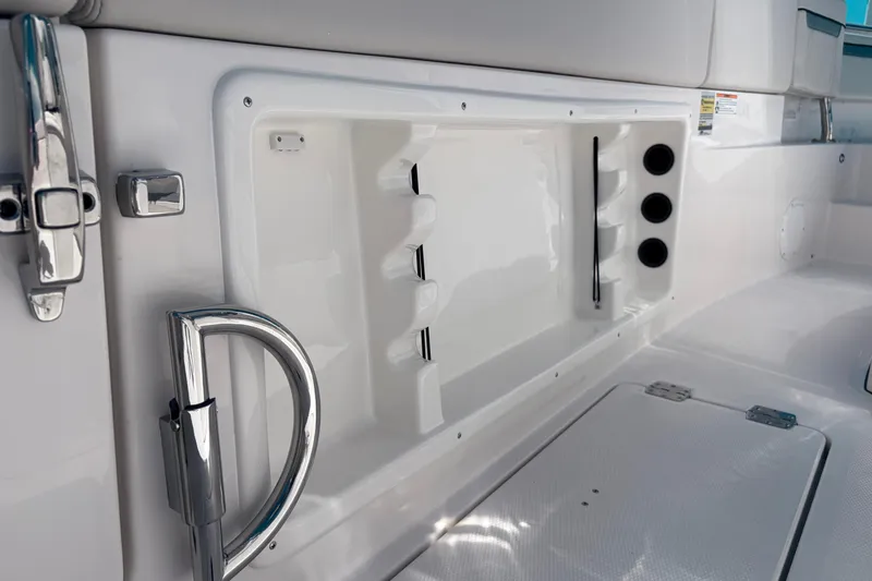 Slide: The Image of Interior view of 2026 Sailfish 252 CC boat, featuring sleek chrome fixtures and storage compartments. - 7
