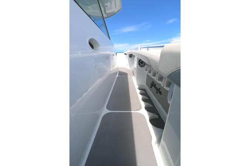 Slide: The Image of 2021 Yellowfin 54 Offshore boat deck with sleek design and clear blue sky. - 10