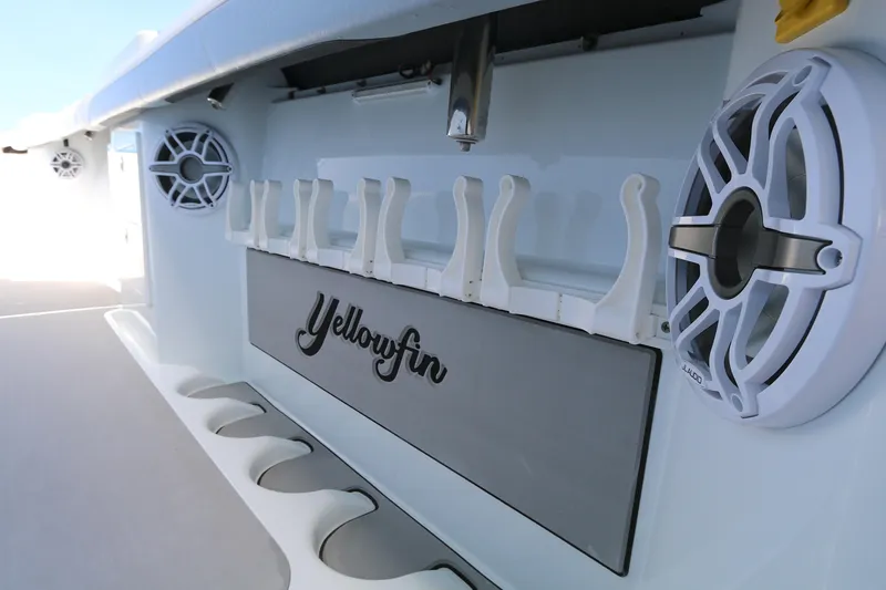 Slide: The Image of 2021 Yellowfin 54 Offshore boat interior with rod holders and speakers. - 11