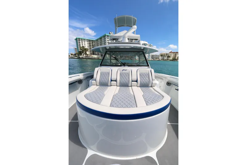 Slide: The Image of 2021 Yellowfin 54 Offshore boat with luxurious seating, docked near waterfront buildings. - 13