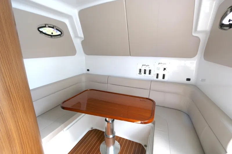 Slide: The Image of Interior of 2021 Yellowfin 54 Offshore boat with seating and wooden table. - 19