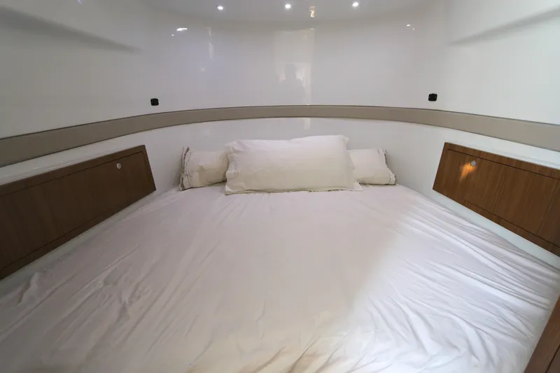 Slide: The Image of Interior cabin of 2021 Yellowfin 54 Offshore boat with bed and wooden storage. - 20