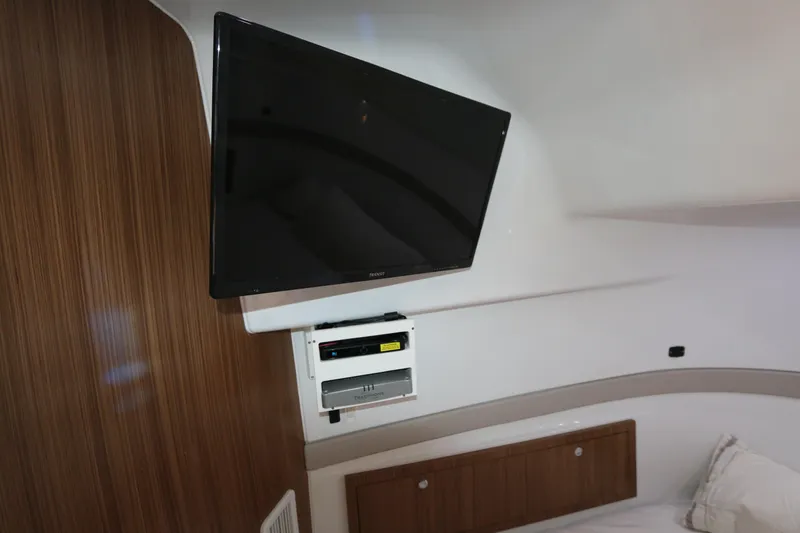 Slide: The Image of Interior of 2021 Yellowfin 54 Offshore boat with mounted TV and wooden paneling. - 21