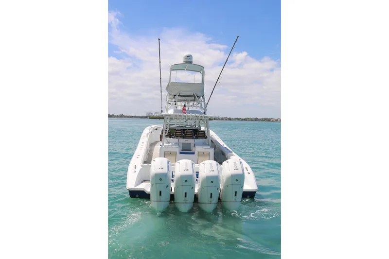 Slide: The Image of 2021 Yellowfin 54 Offshore boat with multiple engines on clear water. - 25