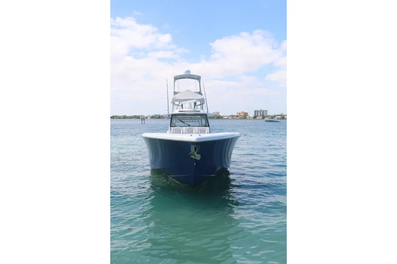 Slide: The Image of 2021 Yellowfin 54 Offshore boat on calm water under a clear sky. - 26