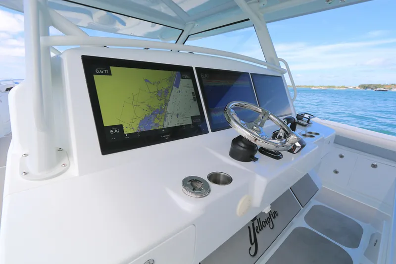 Slide: The Image of Helm of 2021 Yellowfin 54 Offshore boat with navigation screens and steering wheel. - 6