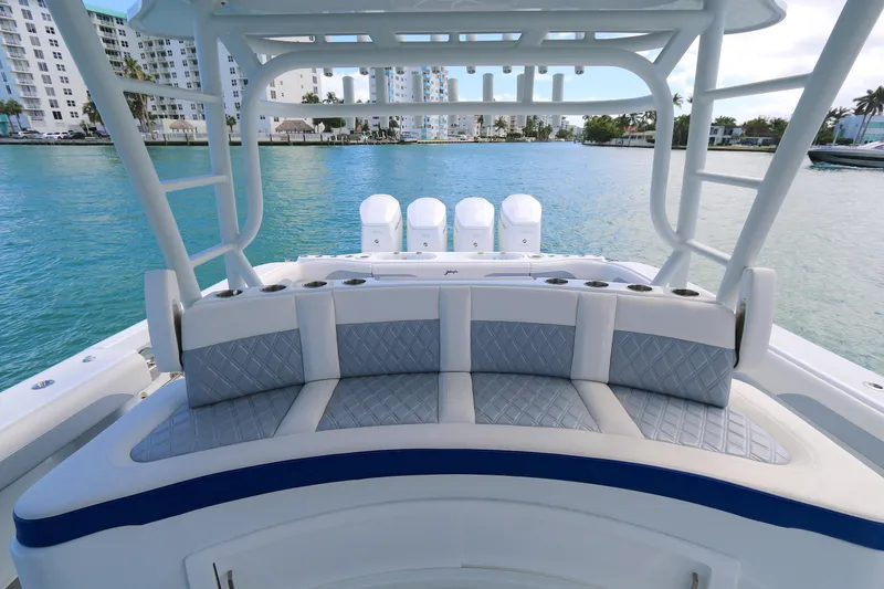 Slide: The Image of 2021 Yellowfin 54 Offshore boat interior with cushioned seating, overlooking a serene waterfront. - 8