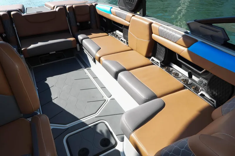 Slide: The Image of Interior of a 2020 Malibu M240 boat with luxurious seating and cup holders. - 10