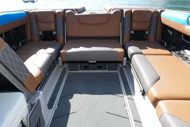 Slide: The Image of Interior seating of a 2020 Malibu M240 boat with brown and gray upholstery. - 12