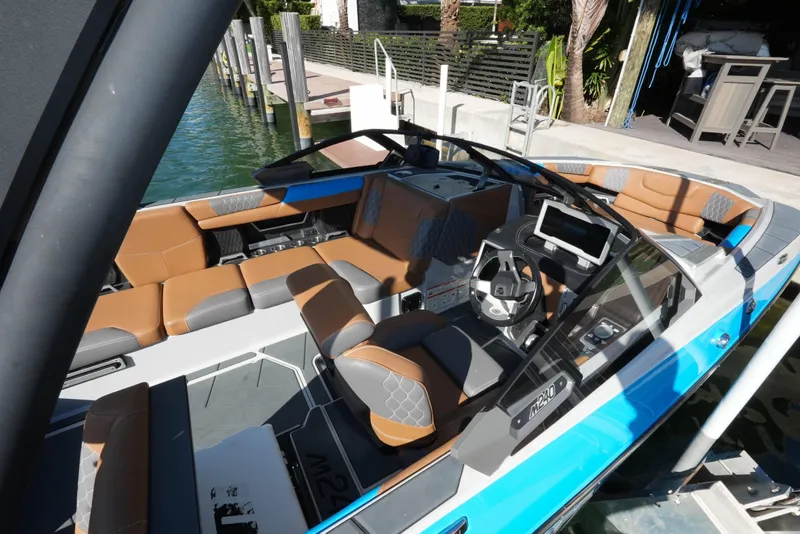 Slide: The Image of 2020 Malibu M240 boat interior with modern dashboard and luxurious seating. - 24