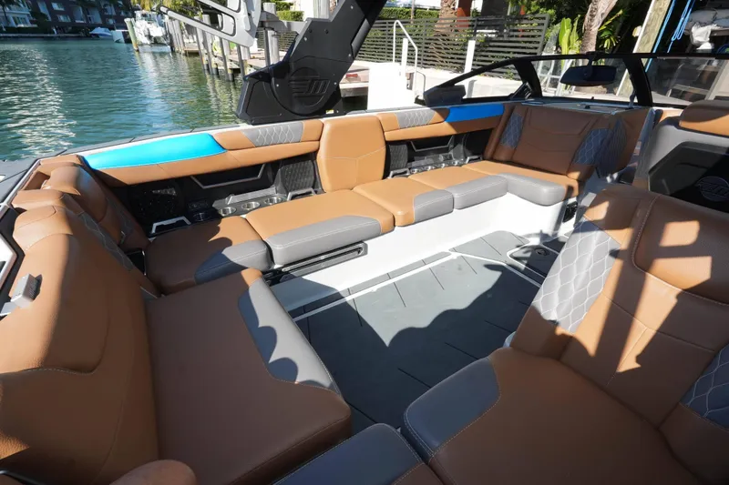 Slide: The Image of Luxurious interior of 2020 Malibu M240 boat with brown and gray seating. - 27
