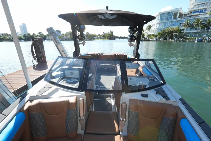 Slide: The Image of 2020 Malibu M240 boat interior with luxurious seating and modern design on a sunny day. - 31