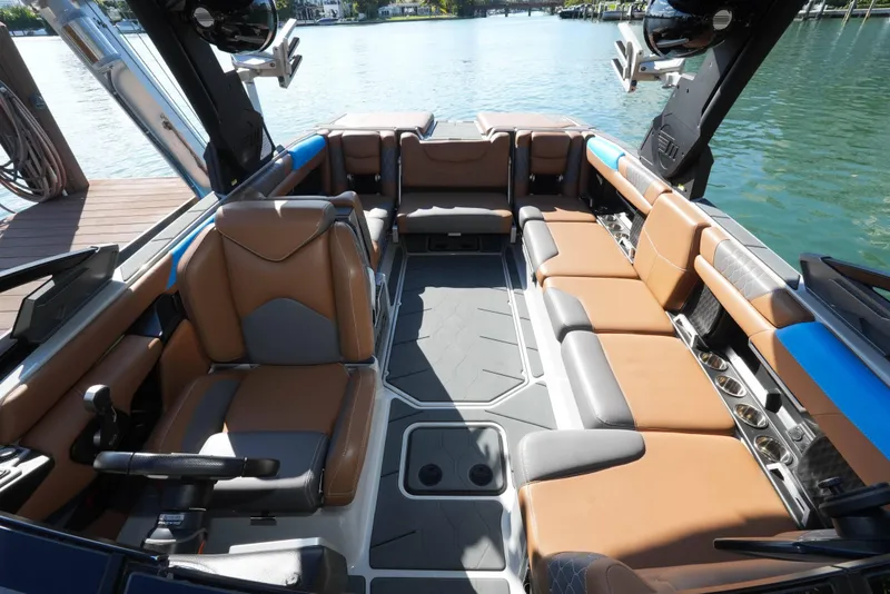 Slide: The Image of Interior of 2020 Malibu M240 boat with luxurious seating and modern design on the water. - 33