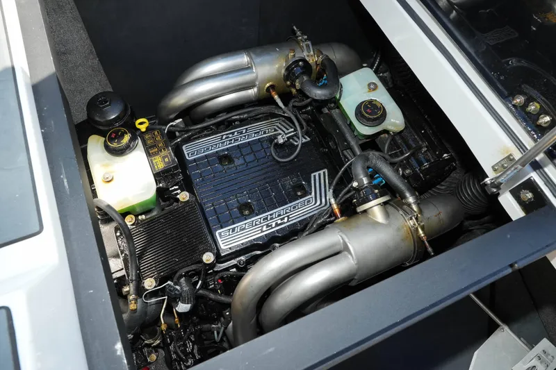 Slide: The Image of 2020 Malibu M240 engine compartment showcasing a supercharged engine with visible components and piping. - 36