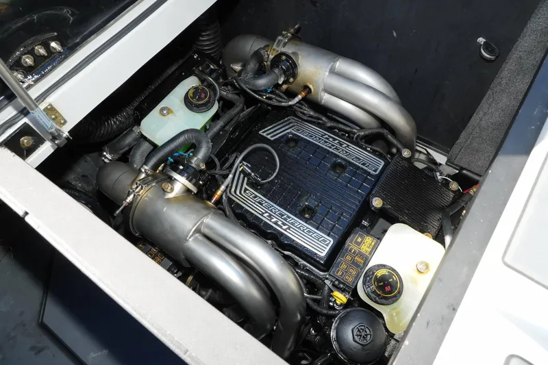 Slide: The Image of 2020 Malibu M240 engine compartment with supercharged engine components and fluid reservoirs. - 38