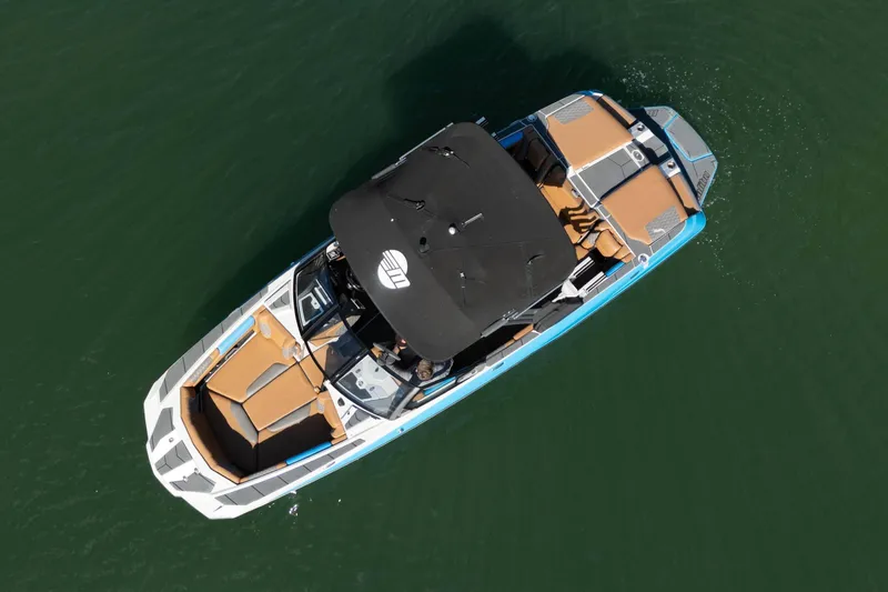 Slide: The Image of Aerial view of 2020 Malibu M240 boat on water, featuring sleek design and spacious seating. - 40