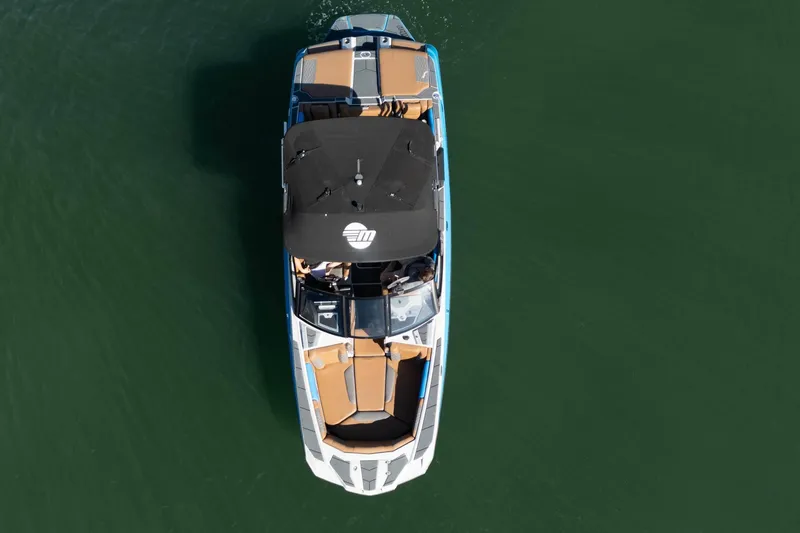Slide: The Image of Overhead view of 2020 Malibu M240 boat on calm green water. - 41