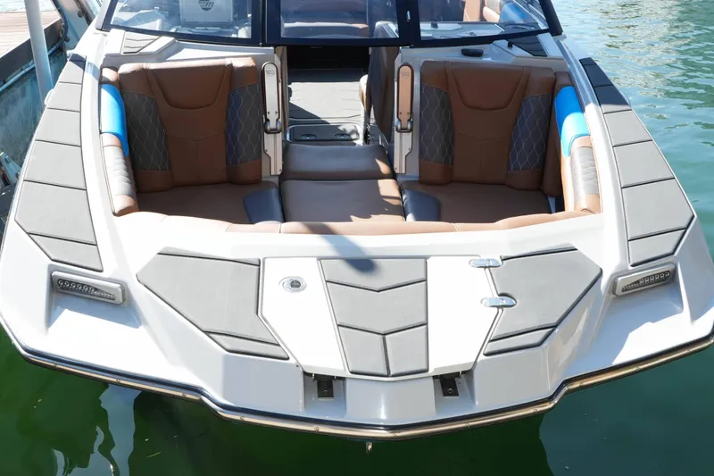 Slide: The Image of 2020 Malibu M240 boat interior with brown seating and modern design. - 6