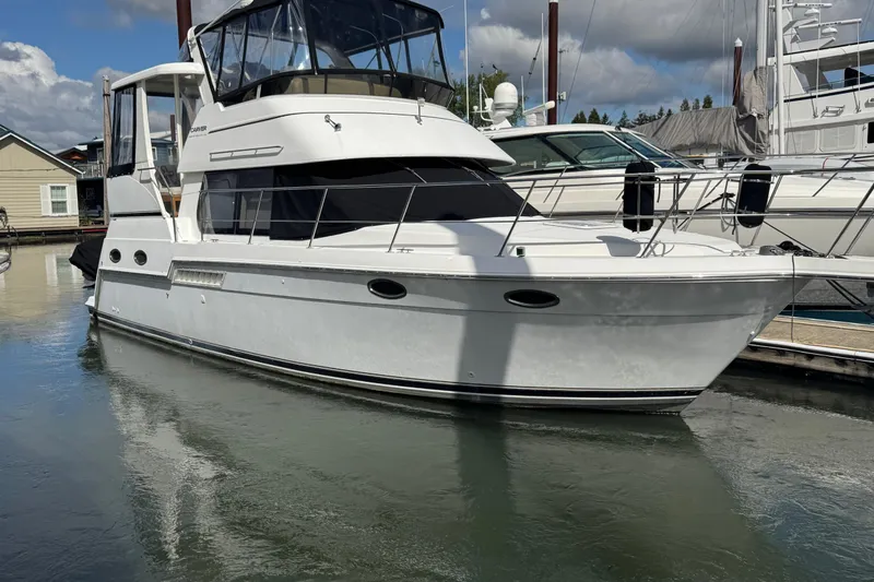 The Image of 2001 Carver 356 Motor Yacht docked at marina, reflecting on calm water. - 0