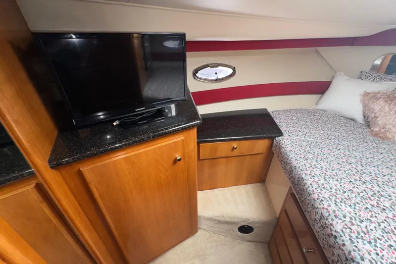 Slide: The Image of Interior of 2001 Carver 356 Motor Yacht with TV, cabinets, and bed. - 12