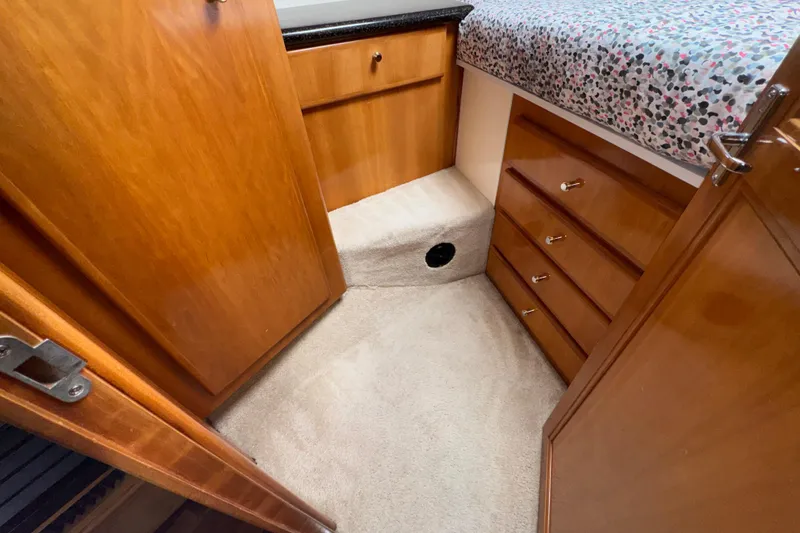 Slide: The Image of Interior of 2001 Carver 356 Motor Yacht with wooden cabinetry and carpeted flooring. - 15