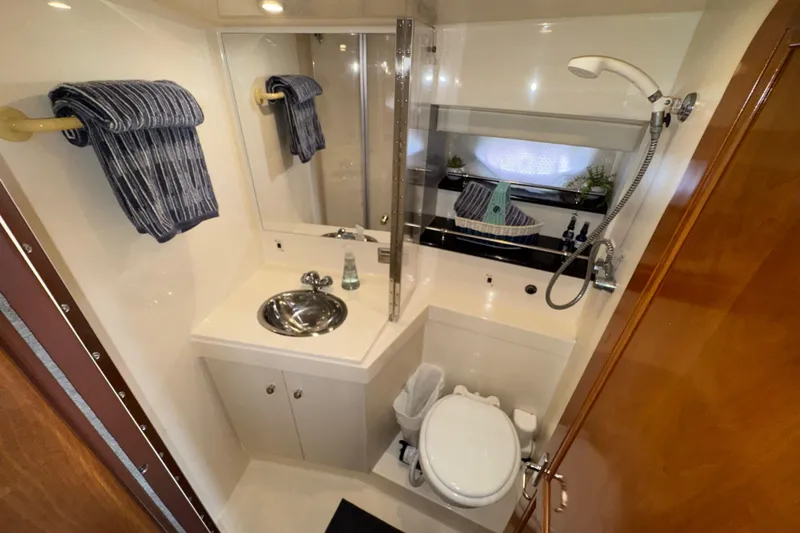 Slide: The Image of Bathroom interior of 2001 Carver 356 Motor Yacht with sink, toilet, and shower. - 16