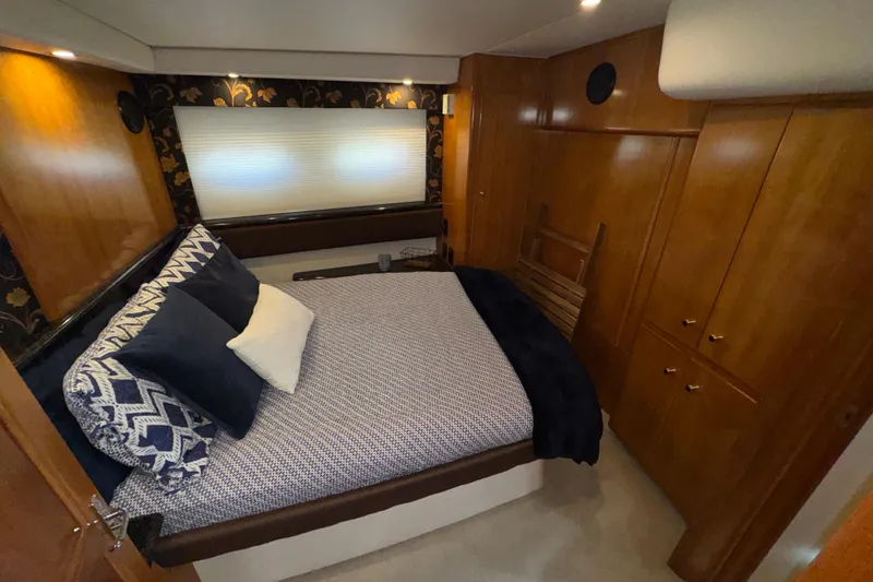 Slide: The Image of Luxurious bedroom interior of 2001 Carver 356 Motor Yacht with elegant wood paneling. - 18