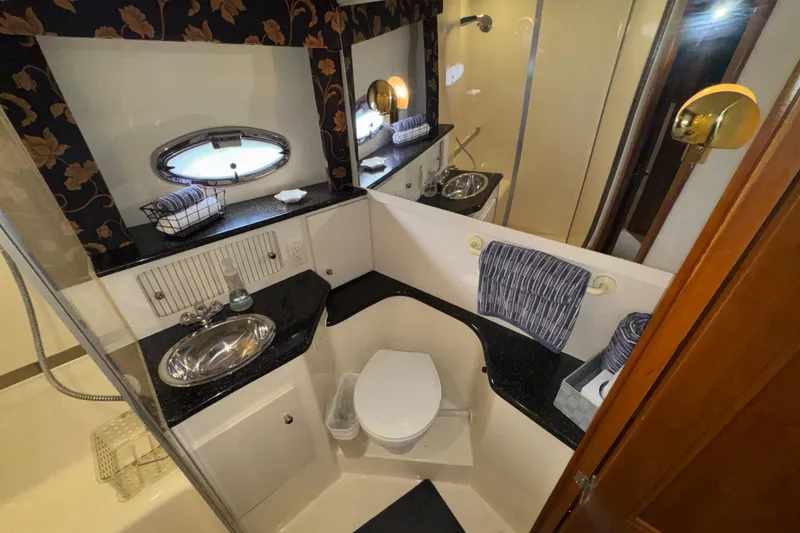 Slide: The Image of Bathroom interior of 2001 Carver 356 Motor Yacht with sink, toilet, and mirror. - 22