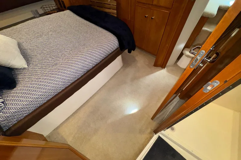 Slide: The Image of Interior of 2001 Carver 356 Motor Yacht with bed and wooden furnishings. - 26