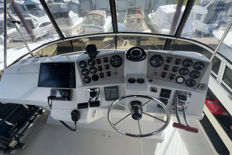 Slide: The Image of Cockpit of 2001 Carver 356 Motor Yacht with steering wheel and control panels. - 28