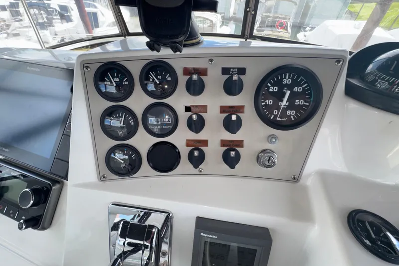 Slide: The Image of Control panel of a 2001 Carver 356 Motor Yacht with gauges and switches. - 32