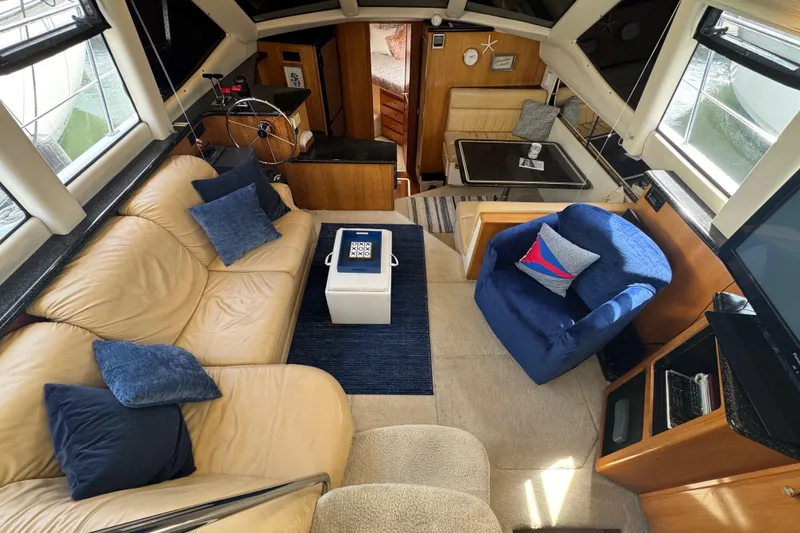 Slide: The Image of Interior of 2001 Carver 356 Motor Yacht with beige and blue seating. - 4