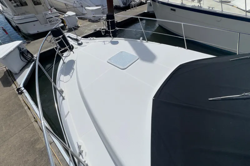 Slide: The Image of 2001 Carver 356 Motor Yacht docked at marina, showcasing sleek deck design. - 49