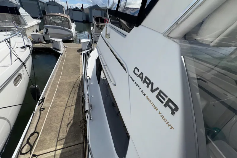 Slide: The Image of 2001 Carver 356 Motor Yacht docked at marina, side view with branding visible. - 50