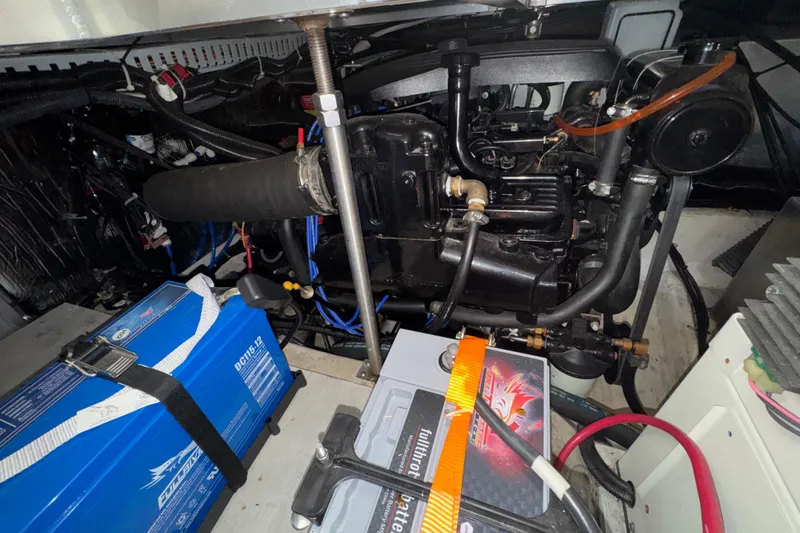 Slide: The Image of Engine compartment of a 2001 Carver 356 Motor Yacht with visible batteries and components. - 51