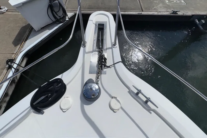 Slide: The Image of Bow of 2001 Carver 356 Motor Yacht docked, featuring anchor chain and cleats. - 53