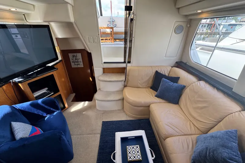 Slide: The Image of Interior of 2001 Carver 356 Motor Yacht with cozy seating and entertainment area. - 6