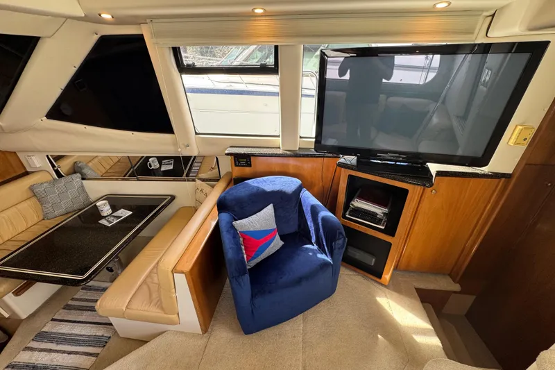 Slide: The Image of Interior of 2001 Carver 356 Motor Yacht with seating, table, and TV. - 7