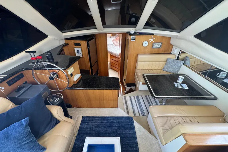 Slide: The Image of Interior of 2001 Carver 356 Motor Yacht with helm, seating, and dining area. - 8