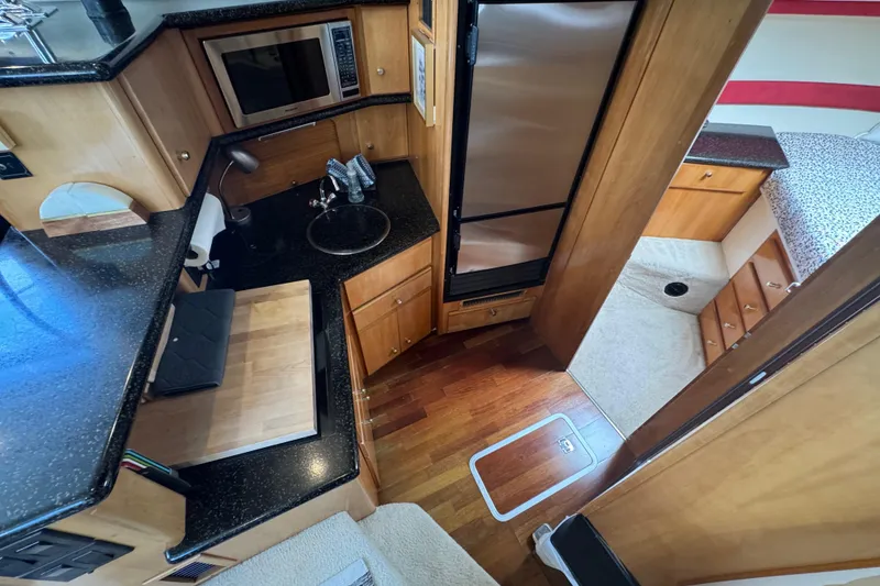 Slide: The Image of Interior of 2001 Carver 356 Motor Yacht with kitchen and sleeping area. - 9