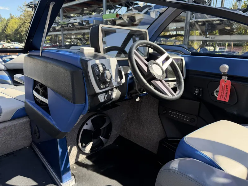 Slide: The Image of Interior of a 2017 Malibu Wakesetter 23 LSV boat, blue-black dashboard. - 15