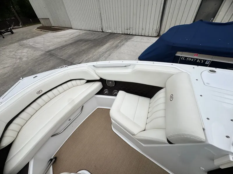 Slide: The Image of Interior of a 2014 Cobalt A25 boat with white leather seating. - 10