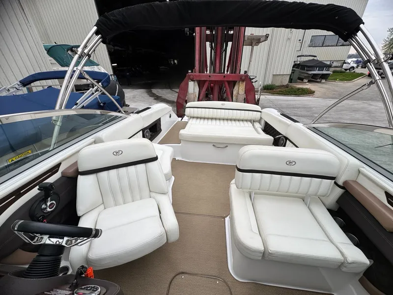 Slide: The Image of Interior of a 2014 Cobalt A25 boat with white leather seats. - 11
