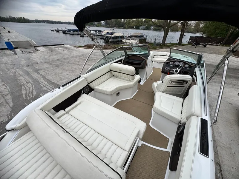Slide: The Image of Interior of a 2014 Cobalt A25 boat by the lakeside. - 4