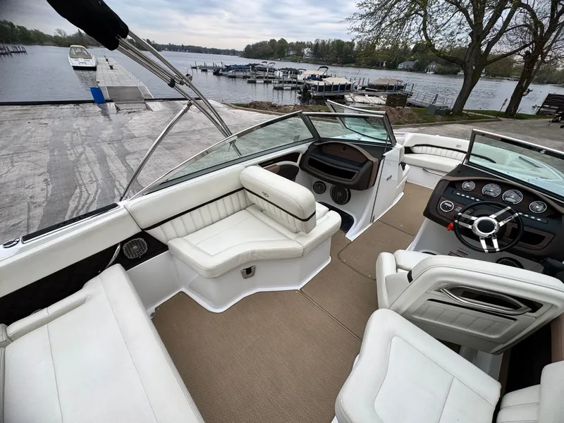 Slide: The Image of Interior of a 2014 Cobalt A25 boat by the lakeside. - 5