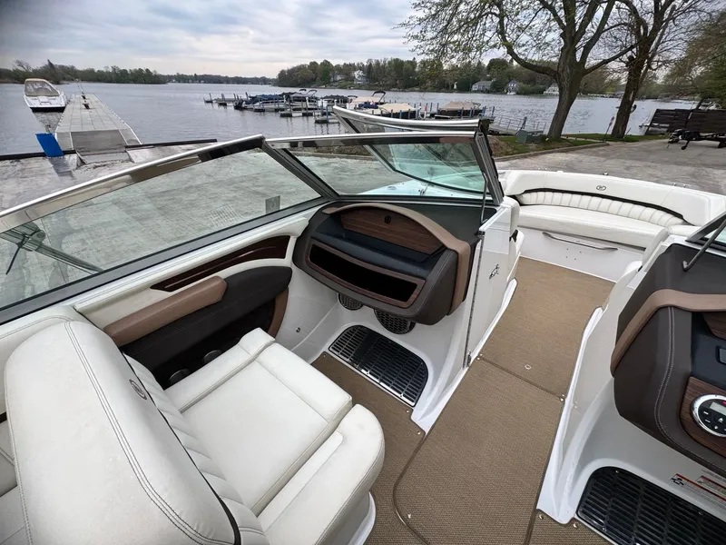 Slide: The Image of Interior of a 2014 Cobalt A25 boat by the lakeside. - 7