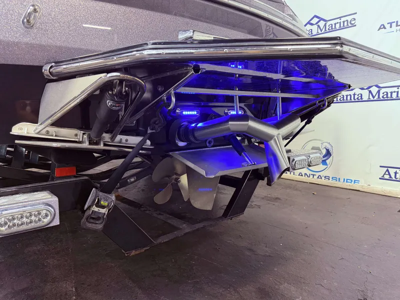 Slide: The Image of 2014 Supra SC350 boat with blue-lit rear and propeller. - 12